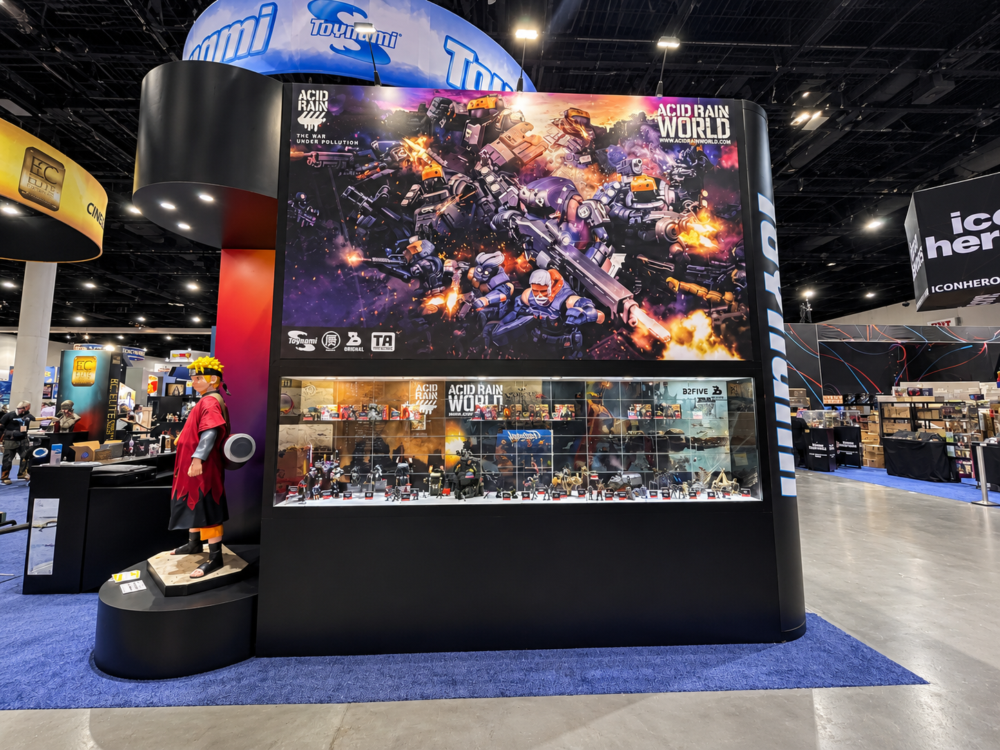 Booth wall with an Acid Rain World graphic above a figure display