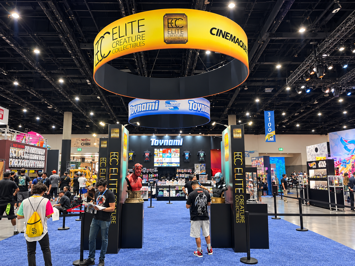 Wide view of a collectibles booth structure with overhead brand rings and display towers
