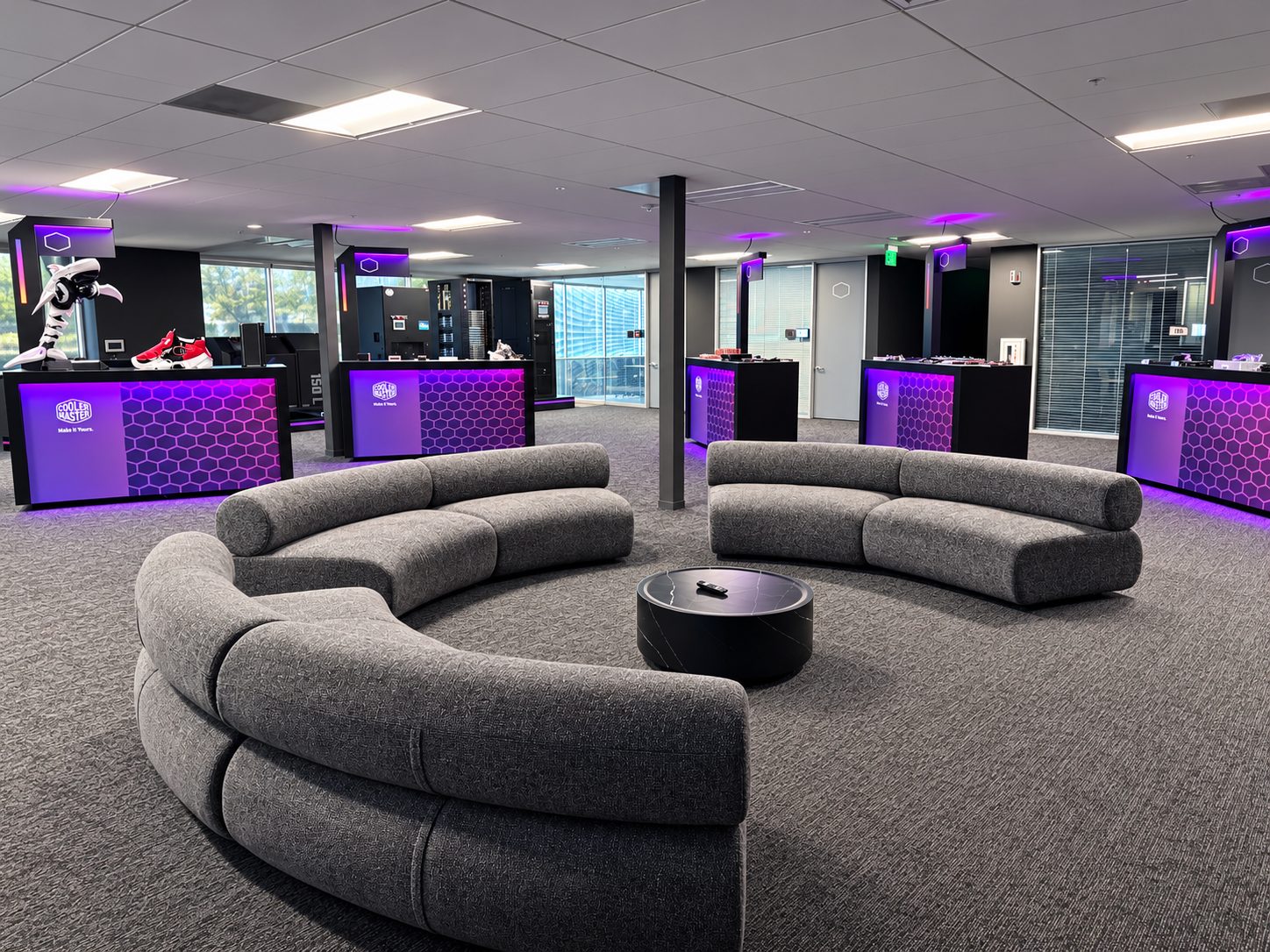 showroom lounge with sofas, counters, and shelving
