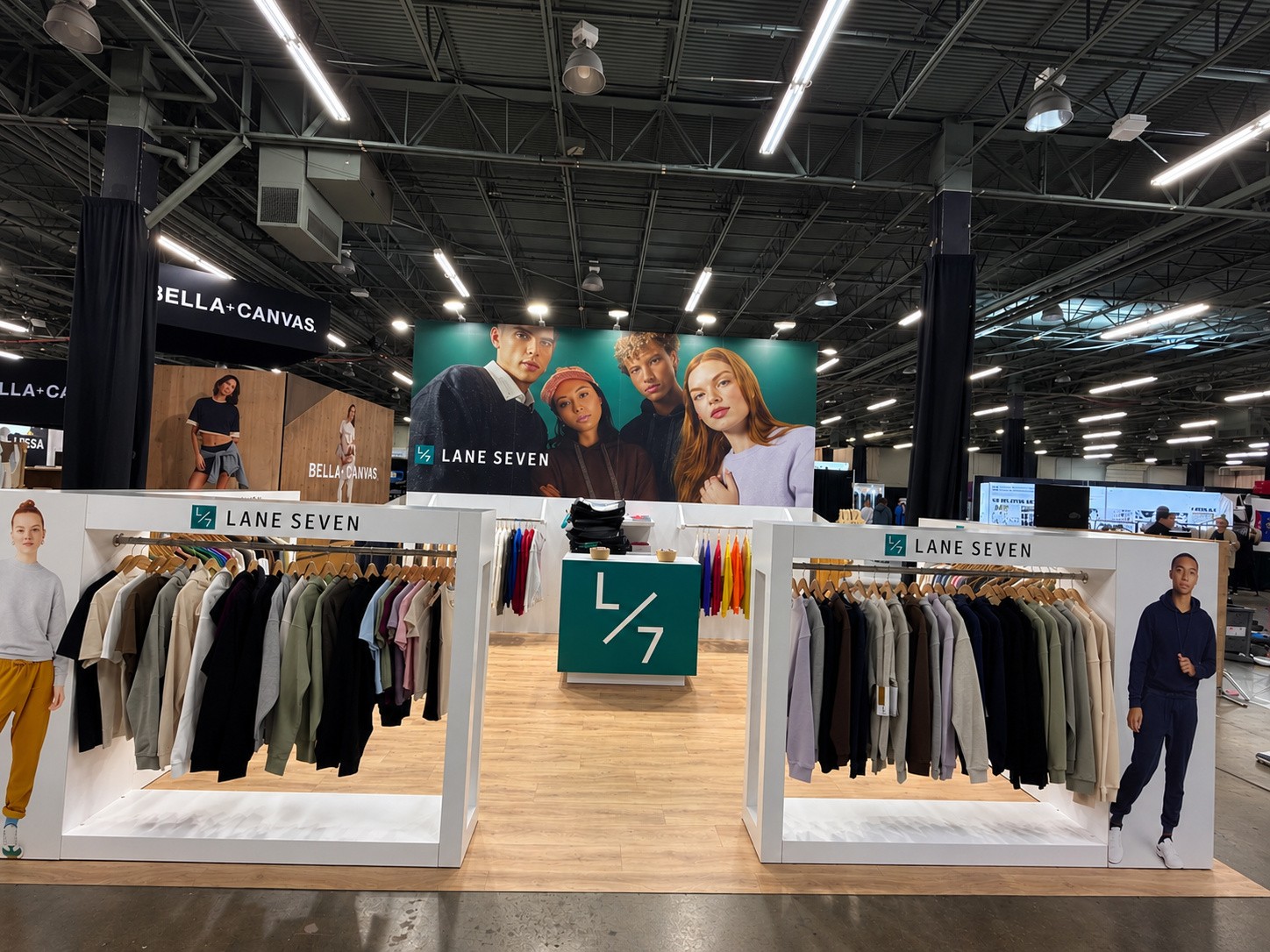 interior of the Lane Seven island with garments on wooden hangers and a green L/7 counter