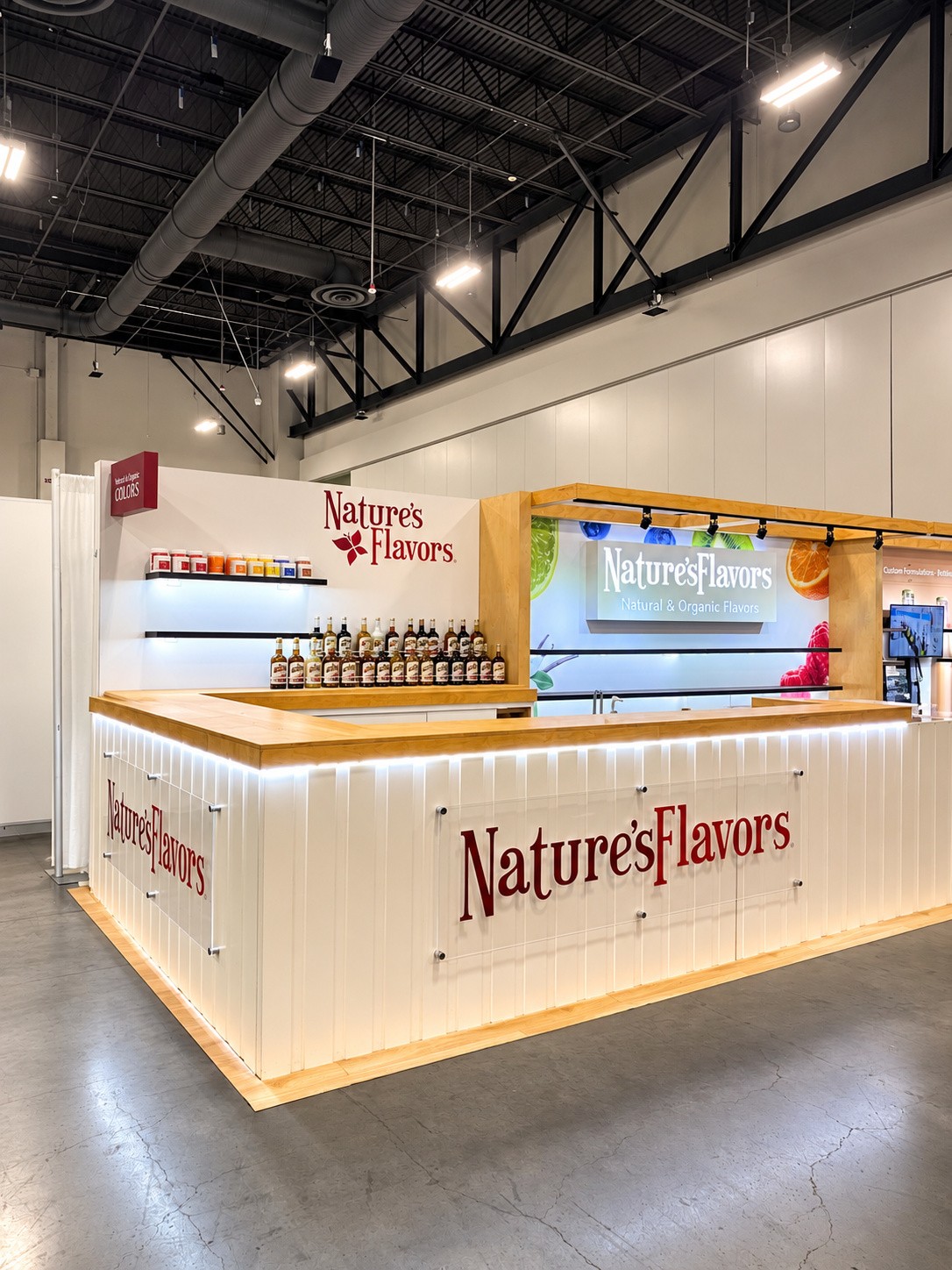 portrait view of the fluted white counter and the backlit Natural and Organic Flavors panel