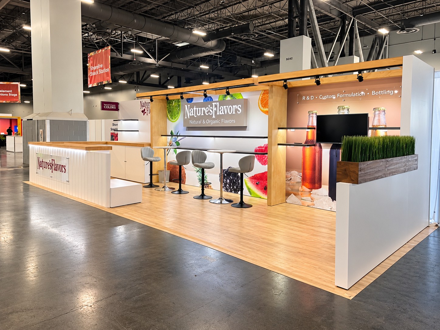 seating side of the inline with four stools, the fruit wall and the R and D sign