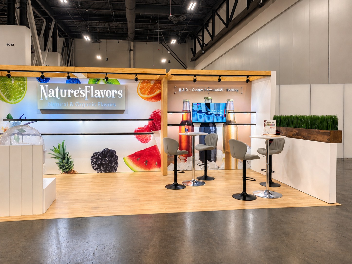 close view of the fruit graphic wall and the R and D, Custom Formulation, Bottling sign